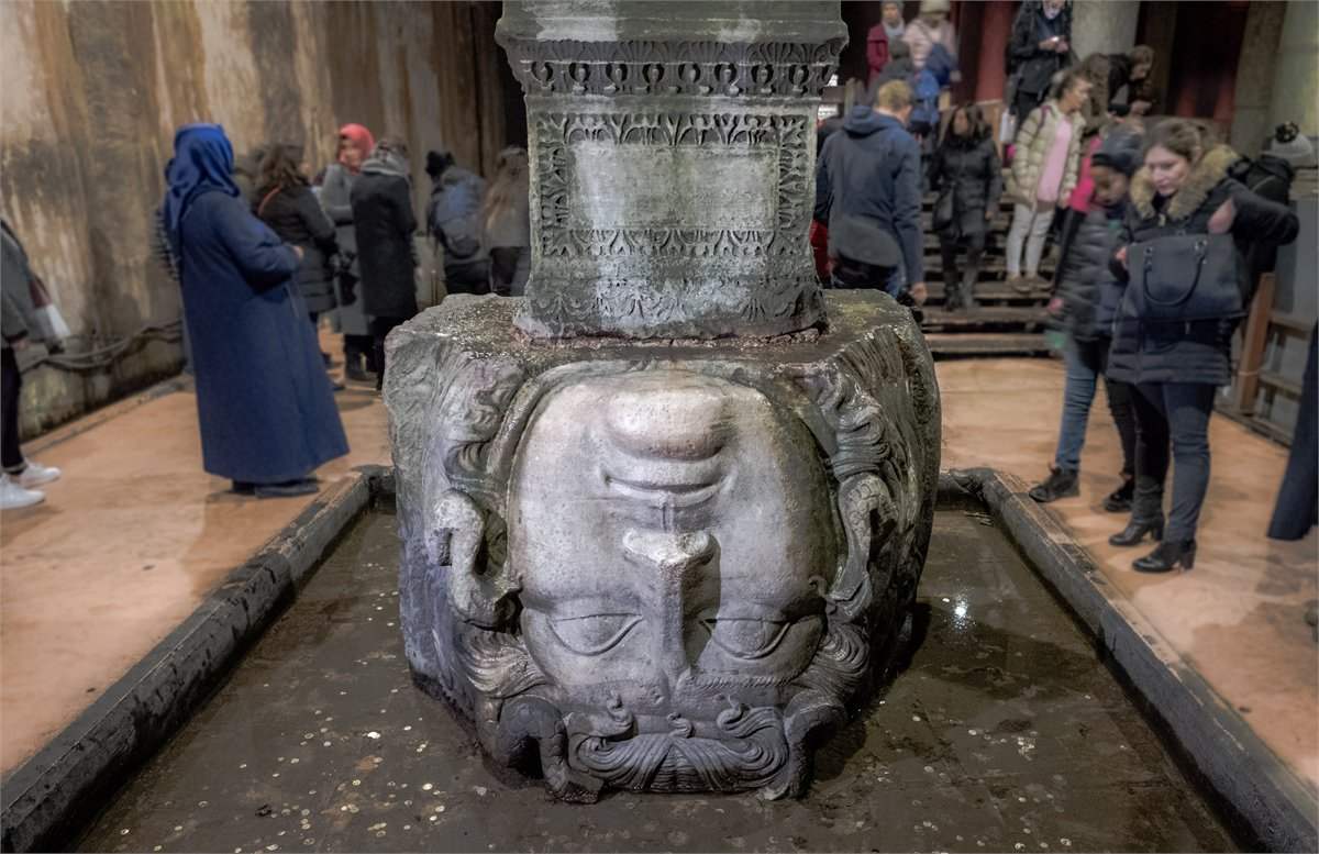 Visitors looking at the Medusa head in the Basilica Cistern, a favorite with children