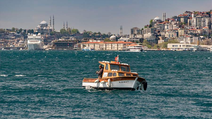 A small boat crossing the Bosphorus with the Süleymaniye Mosque skyline behind A small boat crossing the Bosphorus with the Süleymaniye Mosque skyline behind