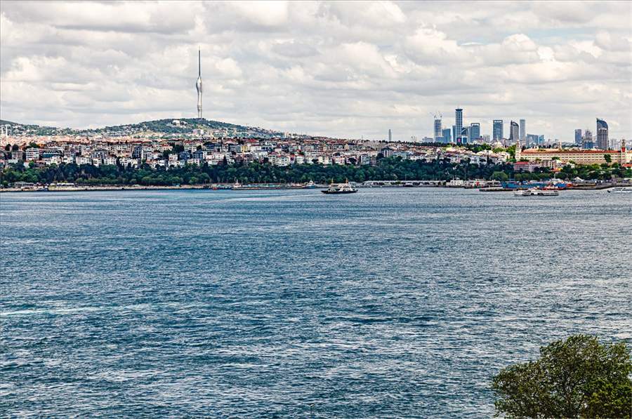 The Asian side of Istanbul seen across the Bosphorus, with a ferry crossing the strait toward the hills of Üsküdar