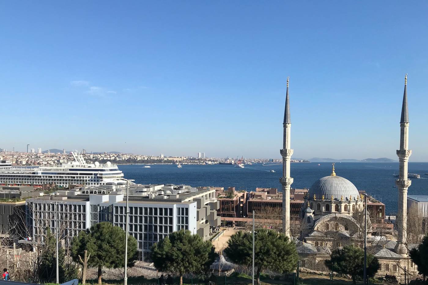 A cruise ship berthed at Galataport on the Bosphorus, with the domes and minarets of the Nusretiye Mosque at Tophane in the foreground