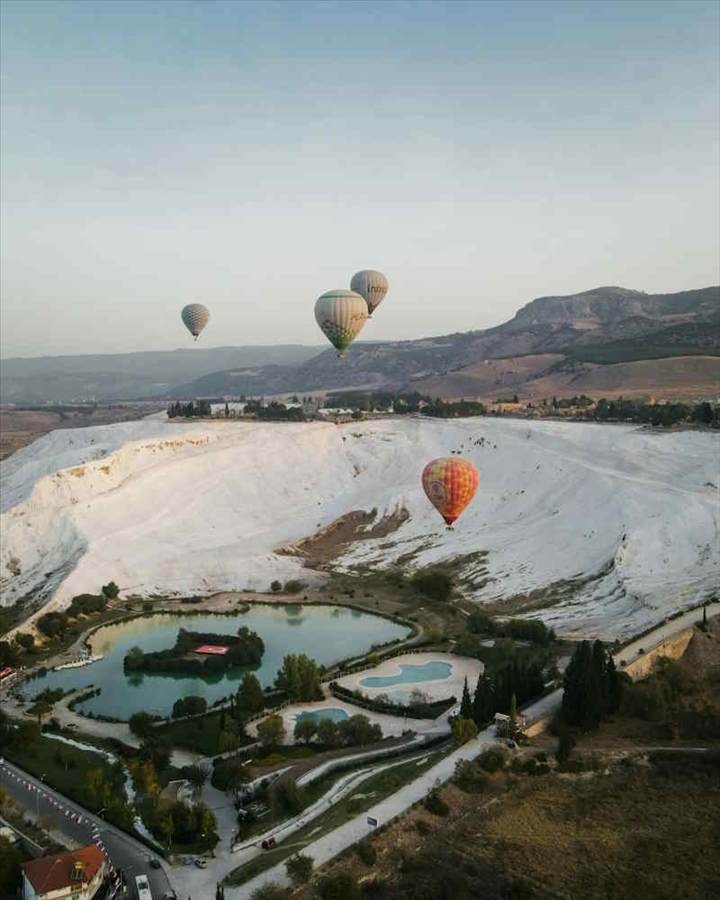 The travertines of Pamukkale below the ruins of ancient Hierapolis The travertines of Pamukkale below the ruins of ancient Hierapolis